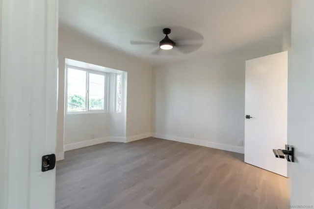 a kitchen with stainless steel appliances granite countertop a refrigerator a sink dishwasher a stove and a refrigerator with wooden floor