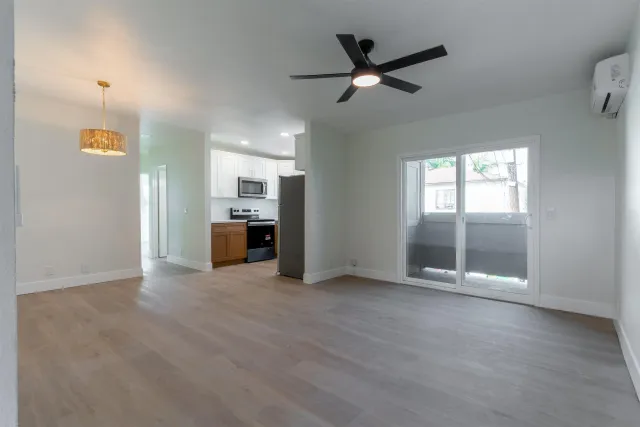 a kitchen with stainless steel appliances granite countertop a sink and a window