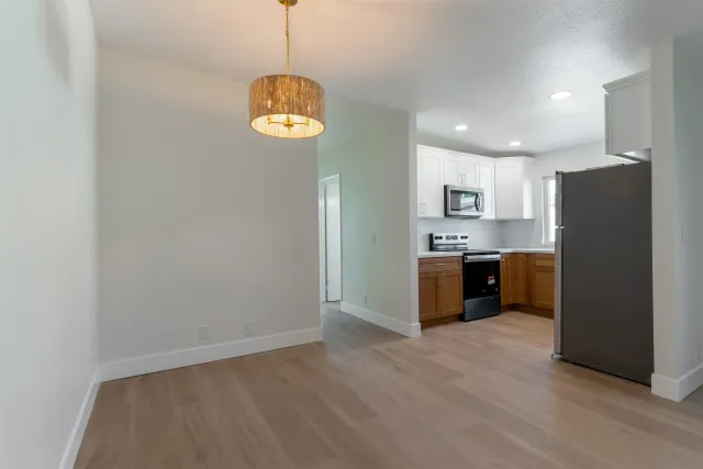 a bathroom with a sink a toilet a mirror and shower