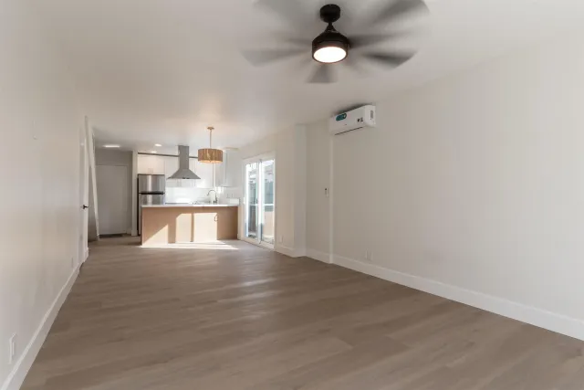 a view of an empty room with wooden floor