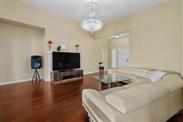 a living room with furniture and wooden floor
