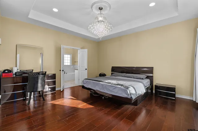 a bedroom with a bed and a chandelier