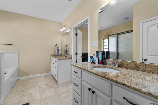 a bathroom with a bathtub and a window