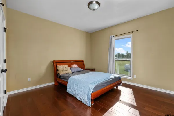 a bathroom with a granite countertop double vanity sink and a mirror