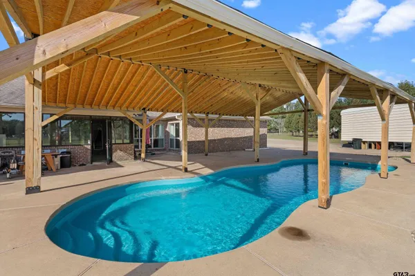 a view of a swimming pool with a patio