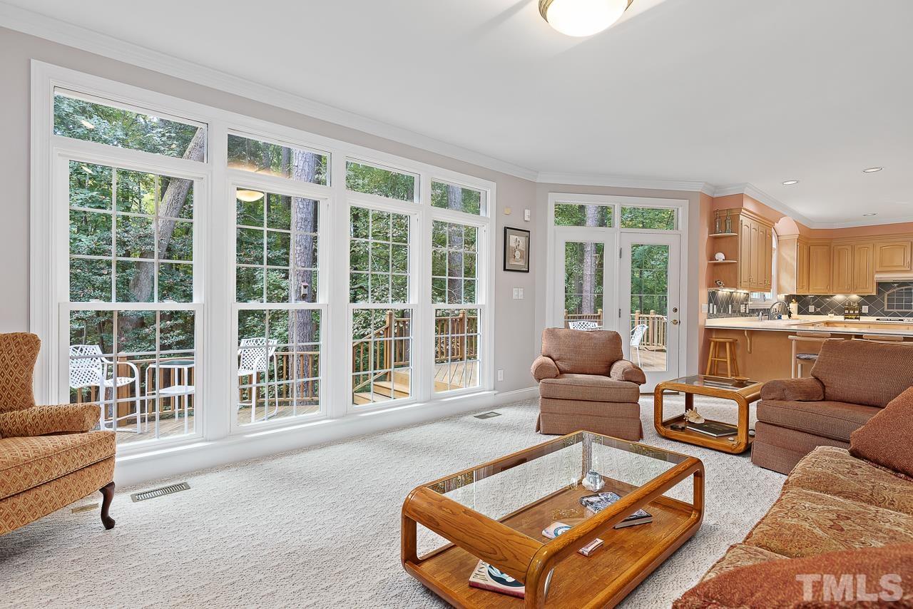 2113 Tibwin Drive Raleigh, NC 27606 - Photo 5 of 30 This wall of windows overlooks the expansive deck and private wooded lot.