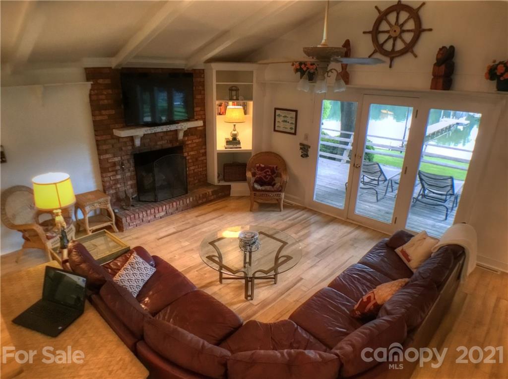 3956 Lake Shore Road South Denver, NC 28037 - Photo 11 of 44 a living room with furniture a fireplace and a flat screen tv