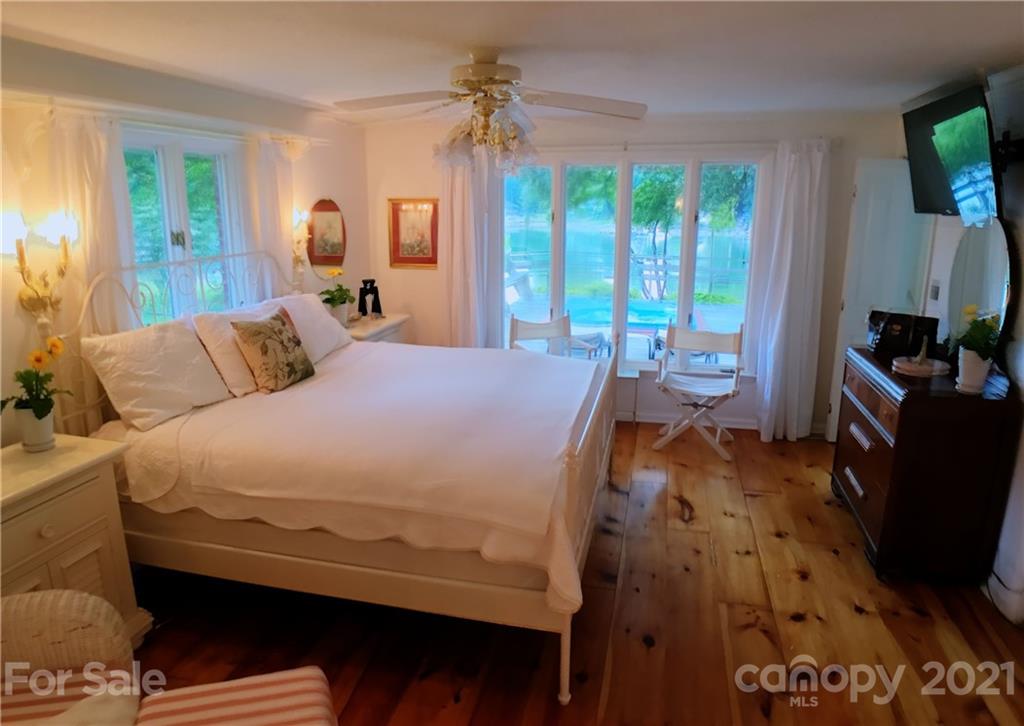 3956 Lake Shore Road South Denver, NC 28037 - Photo 15 of 44 a bedroom with a bed and large windows