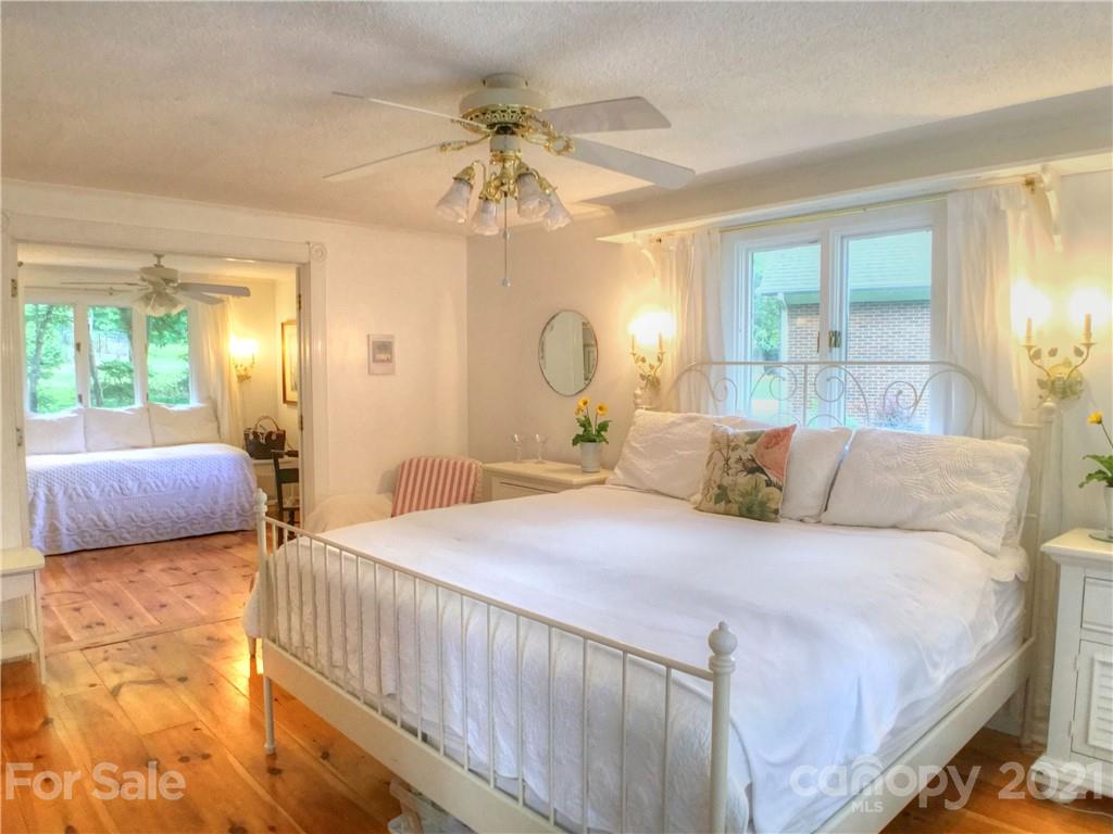3956 Lake Shore Road South Denver, NC 28037 - Photo 16 of 44 a bedroom with a bed and a chandelier