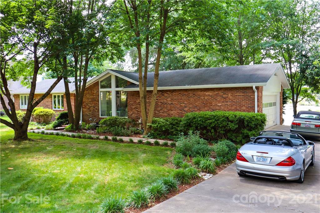 3956 Lake Shore Road South Denver, NC 28037 - Photo 3 of 44 a front view of a house with garden