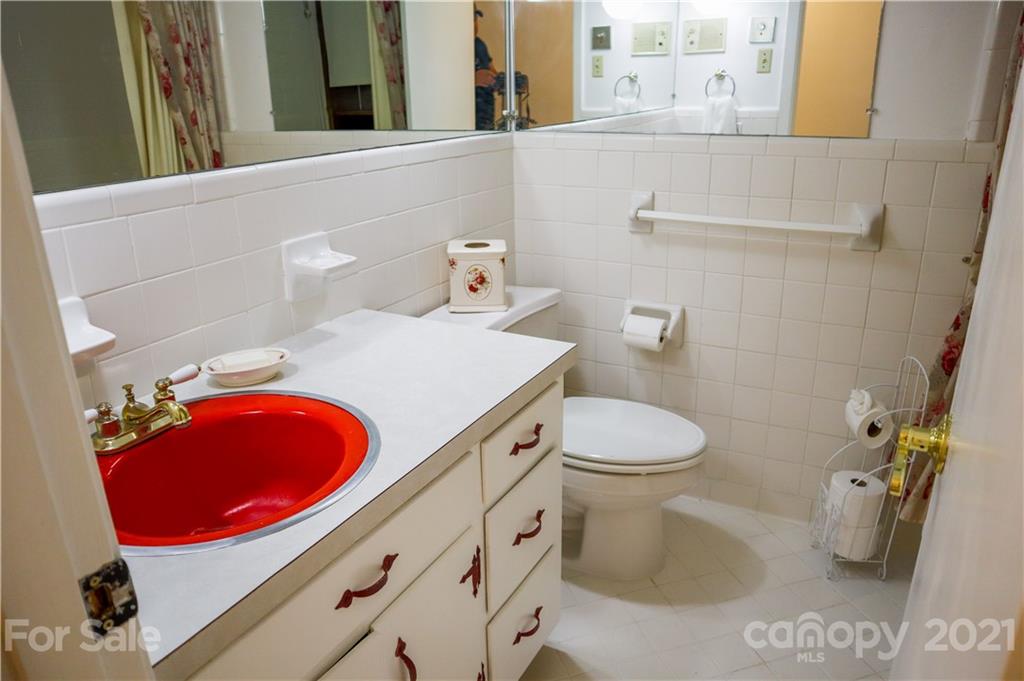 3956 Lake Shore Road South Denver, NC 28037 - Photo 21 of 44 a bathroom with a toilet a sink and a mirror