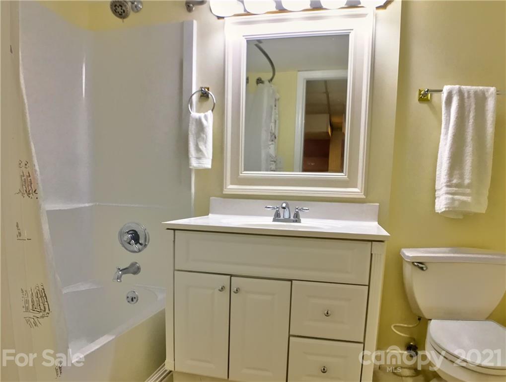 3956 Lake Shore Road South Denver, NC 28037 - Photo 28 of 44 a bathroom with a granite countertop toilet a sink and a bathtub