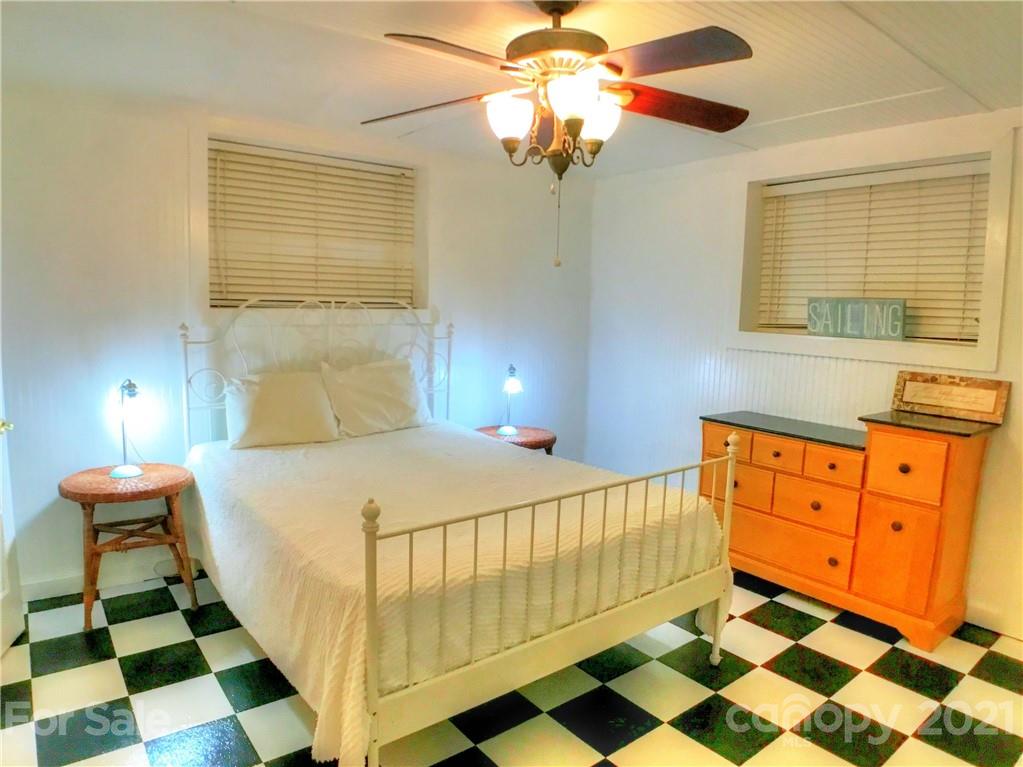 3956 Lake Shore Road South Denver, NC 28037 - Photo 29 of 44 a bedroom with a bed and a lamp on dresser