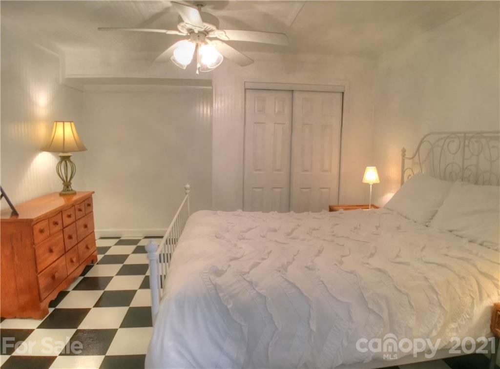 3956 Lake Shore Road South Denver, NC 28037 - Photo 30 of 44 a bedroom with a bed and a lamp