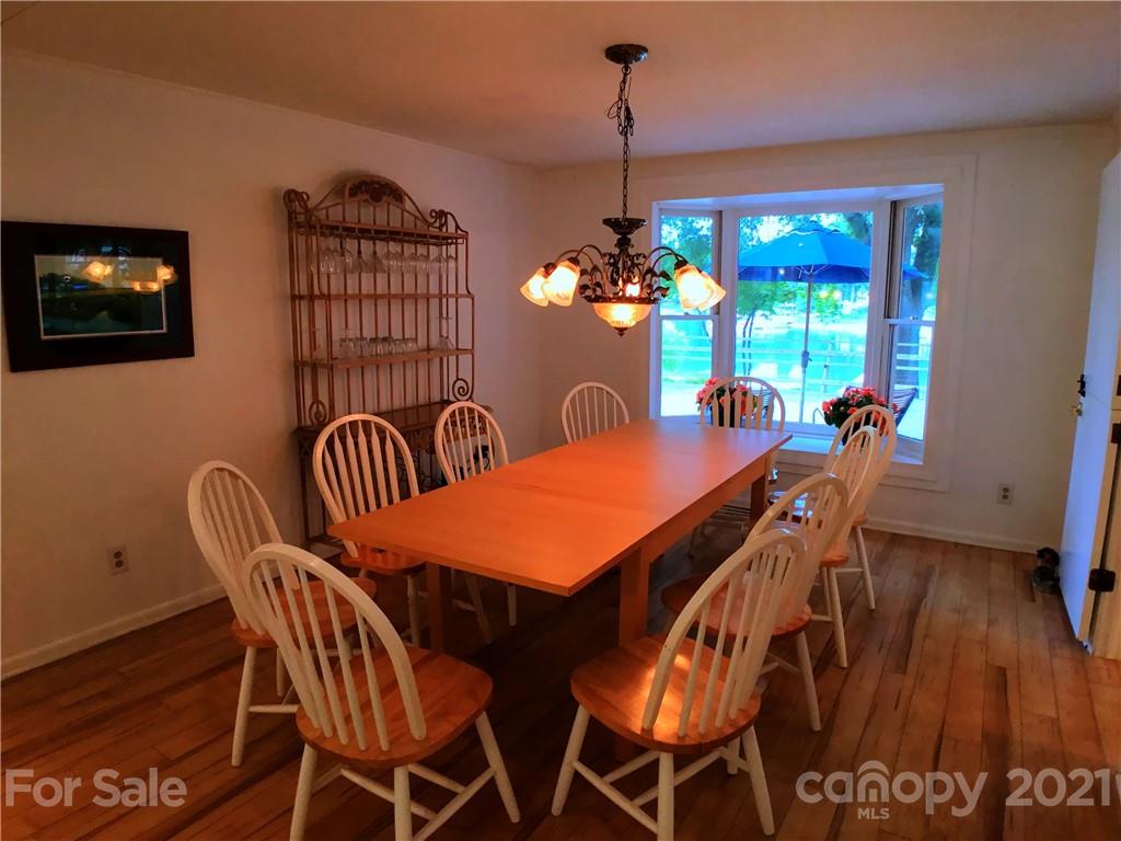 3956 Lake Shore Road South Denver, NC 28037 - Photo 8 of 44 a view of a dining room with furniture wooden floor and chandelier