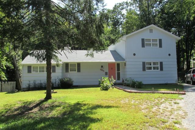 2825 Old Town Road Bridgeport, CT 06606 - Photo 1 of 1 a front view of a house with a yard