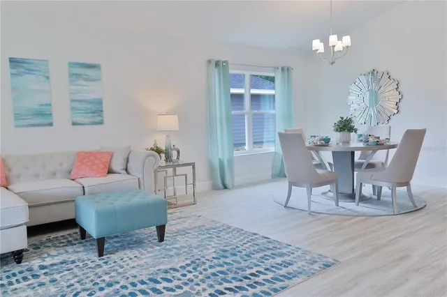 a living room with furniture a lamp a rug and a window