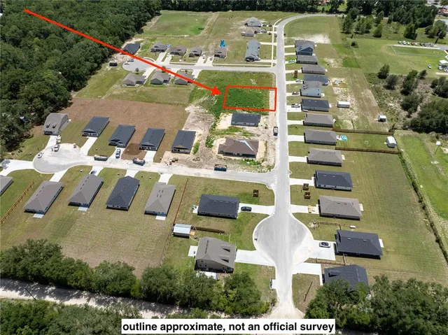 an aerial view of residential houses with outdoor space and river