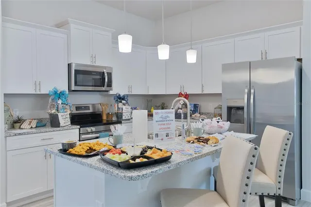 a kitchen with a sink stove and refrigerator