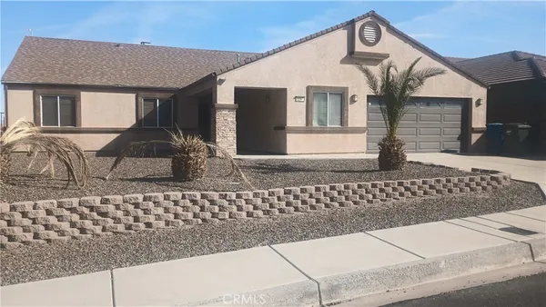 a front view of a house with a bench