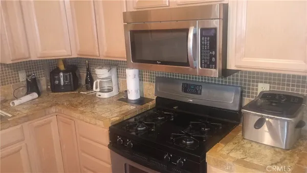a kitchen with stainless steel appliances granite countertop a sink and a stove