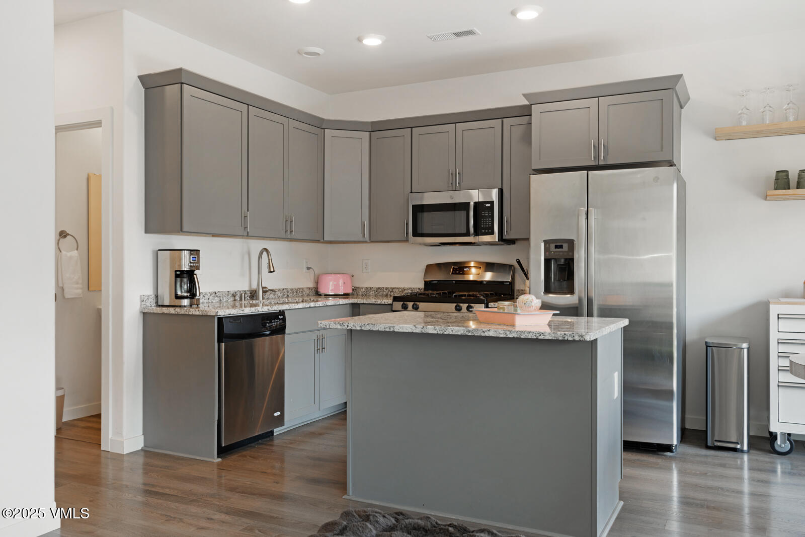 32 Flat Tops Court, Unit L3 Eagle, CO 81631 - Photo 2 of 28 a kitchen with kitchen island a refrigerator sink and cabinets