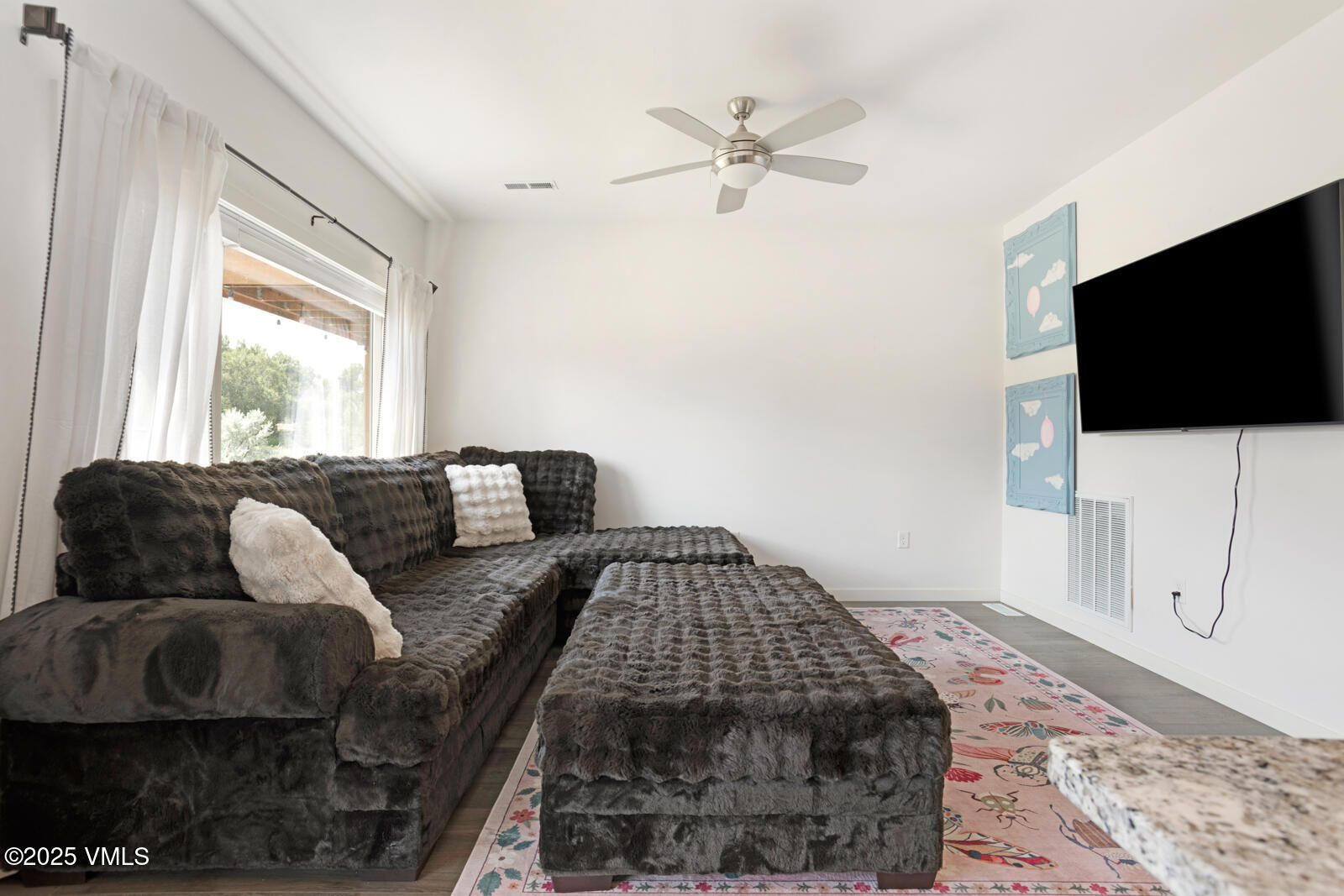 32 Flat Tops Court, Unit L3 Eagle, CO 81631 - Photo 8 of 28 a living room with furniture and a flat screen tv