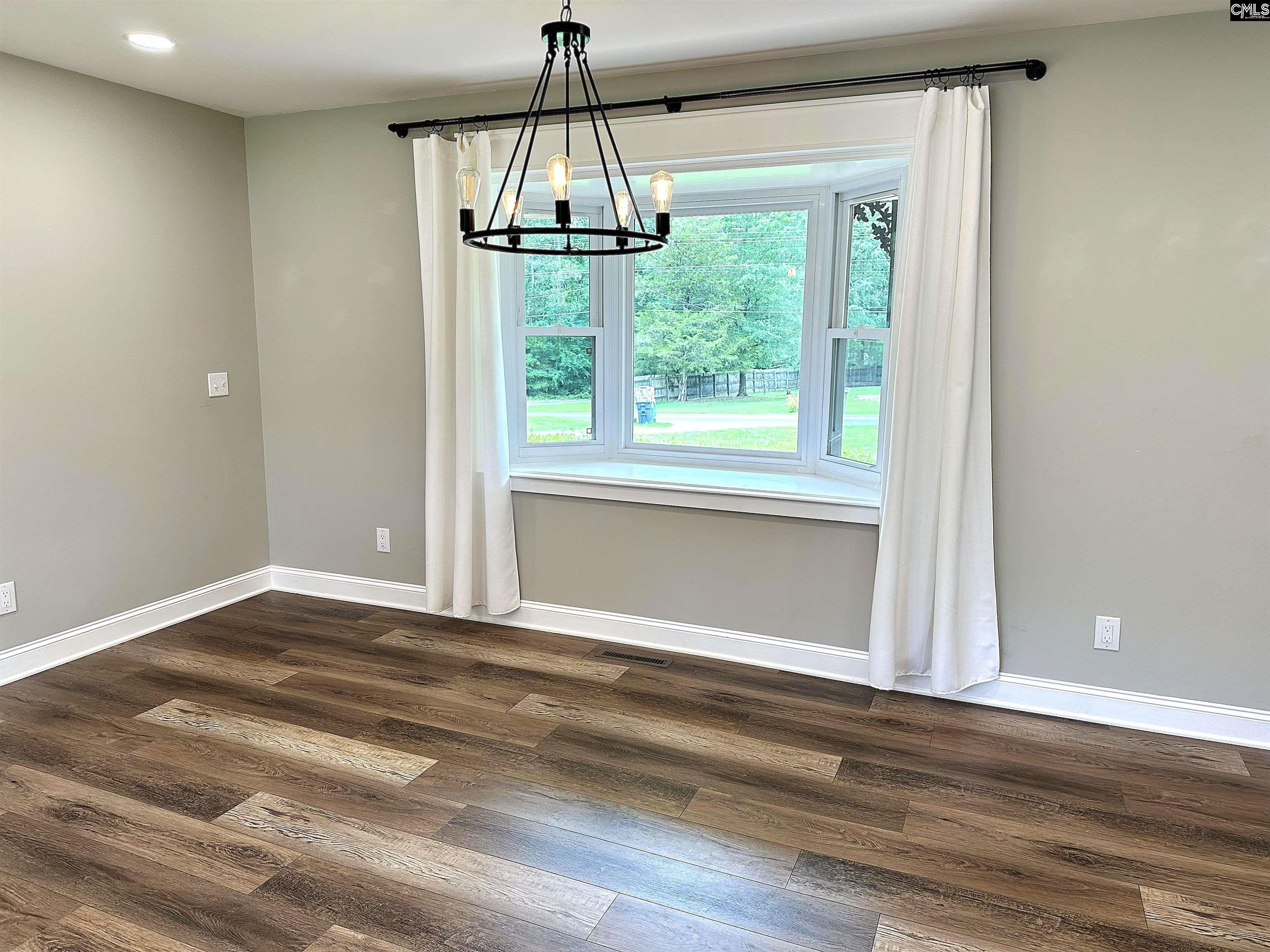 535 Sandbar Road Chapin, SC 29036 - Photo 12 of 23 a view of an empty room with wooden floor and a window