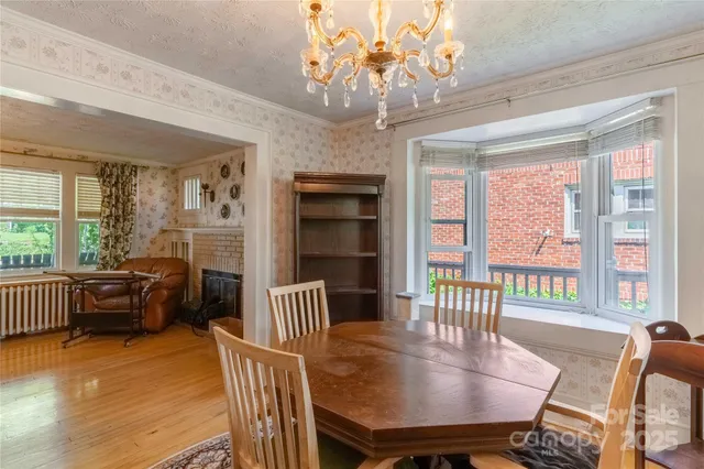 a dining room with furniture a chandelier and window