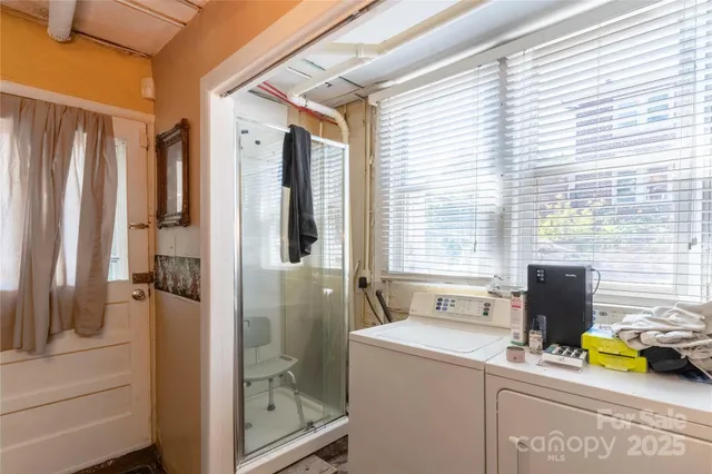 a view of a patio with table and chairs under an umbrella