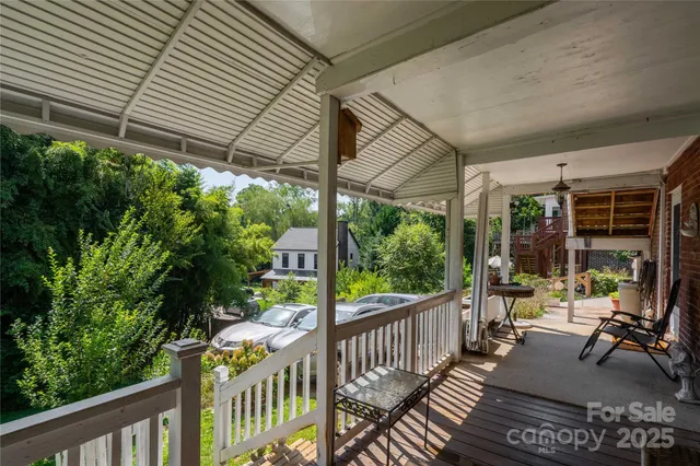 a view of a porch with furniture and garden
