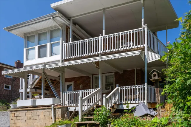 a view of a chair and tables in the backyard of the house