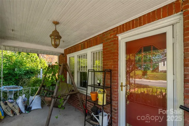 a living room with furniture a fireplace and a chandelier