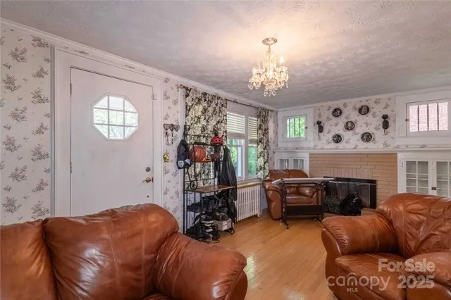 a living room with furniture a window and a flat screen tv
