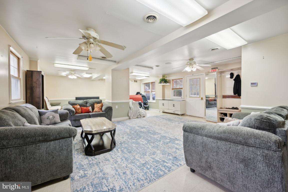 323 Palmer Street Riverside, NJ 08075 - Photo 13 of 30 a living room with furniture and a chandelier