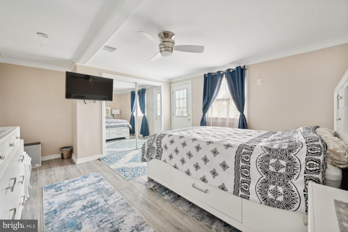 323 Palmer Street Riverside, NJ 08075 - Photo 19 of 30 a bedroom with a large bed and a flat screen tv