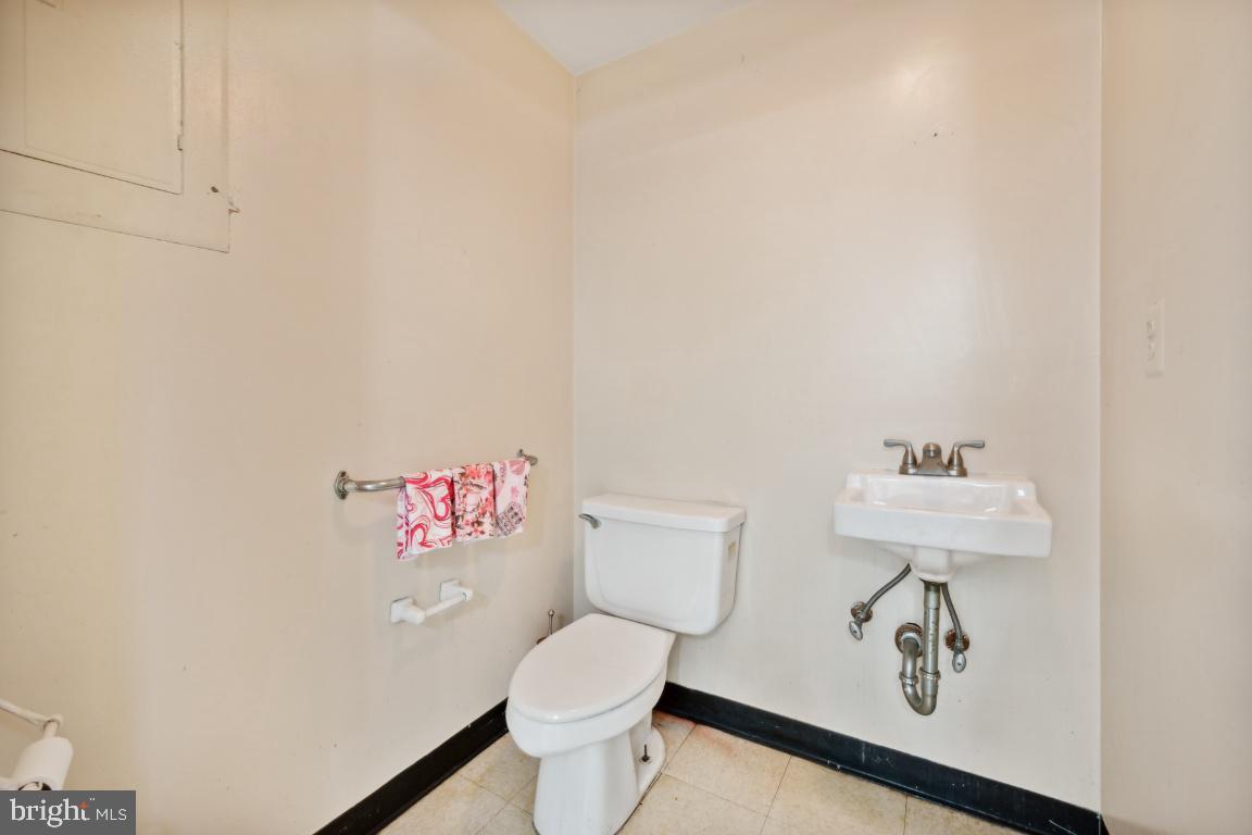323 Palmer Street Riverside, NJ 08075 - Photo 30 of 30 a white toilet sitting next to a bathroom sink