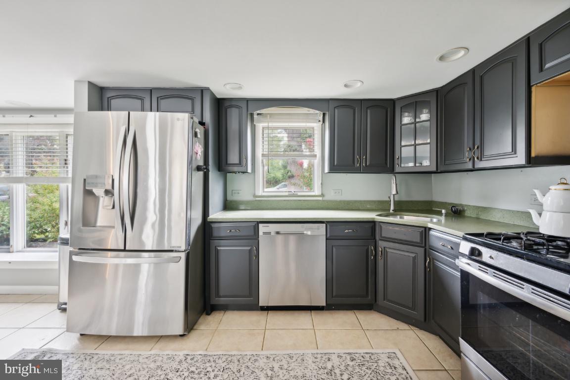 323 Palmer Street Riverside, NJ 08075 - Photo 3 of 30 a kitchen with granite countertop a refrigerator stove top oven and sink