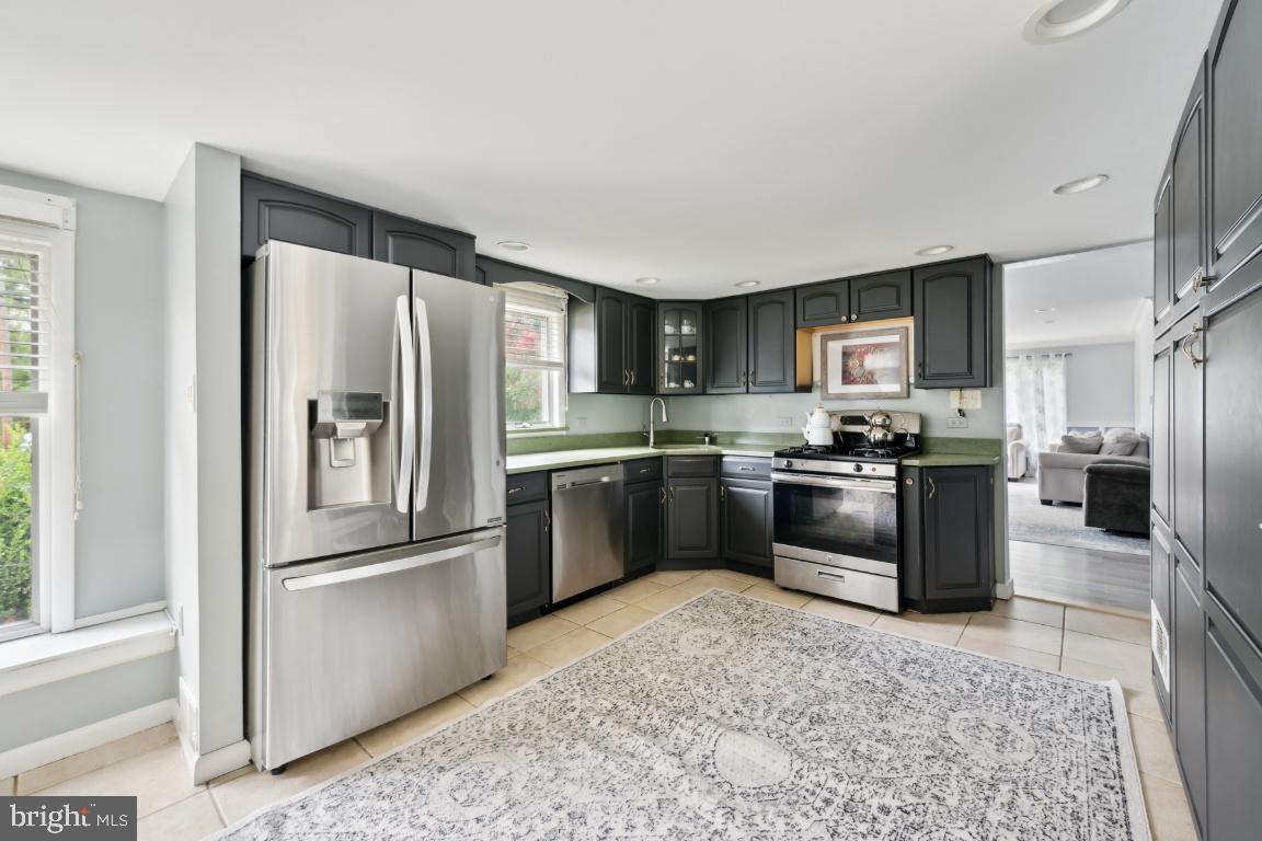 323 Palmer Street Riverside, NJ 08075 - Photo 4 of 30 a kitchen with stainless steel appliances granite countertop a refrigerator sink and stove