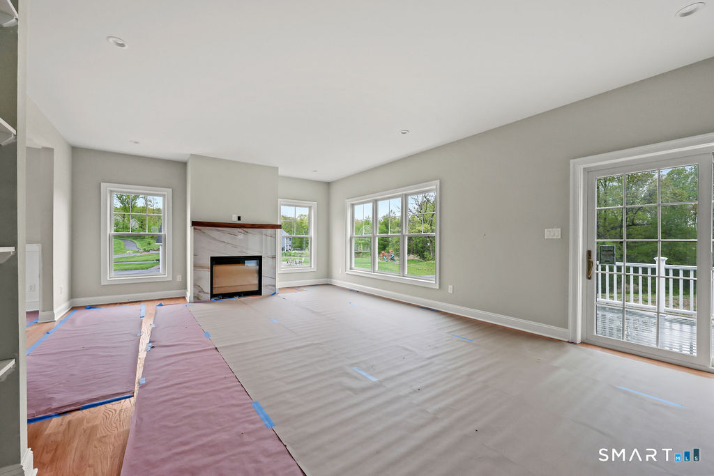 8 Ridgewood Club Road Prospect, CT 06712 - Photo 10 of 40 wooden floor fireplace and windows in an empty room