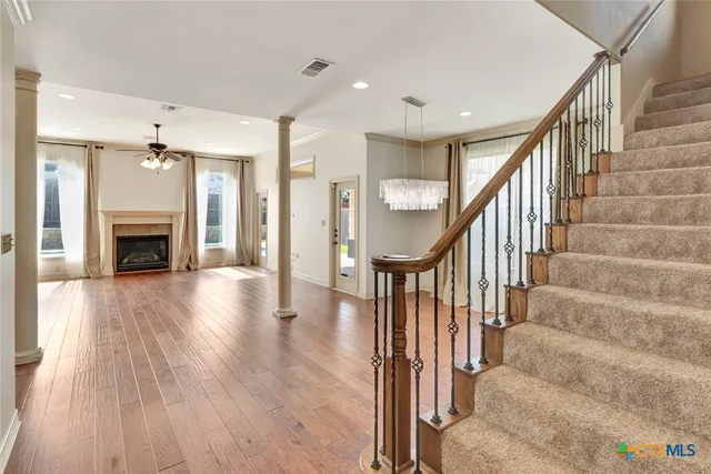 a view of entryway and hall with wooden floor