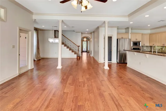 a view of a kitchen with wooden floor and a kitchen
