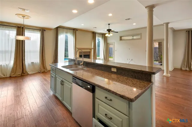 a view of a kitchen counter space and wooden floor