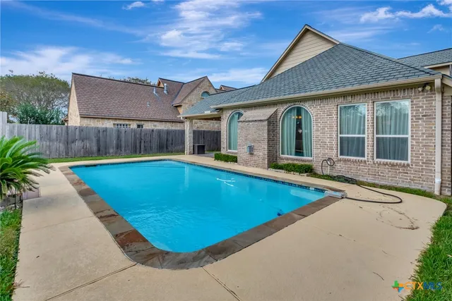 a view of a house with swimming pool and porch