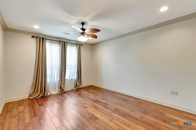 wooden floor in an empty room with a window