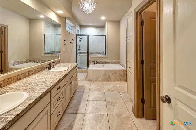 a bathroom with a granite countertop sink mirror and shower