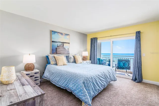 a bedroom with a bed and a lamp next to a window