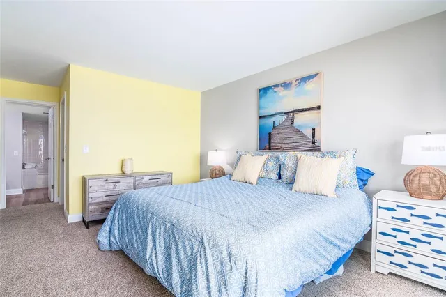 a bedroom with a bed and a lamp