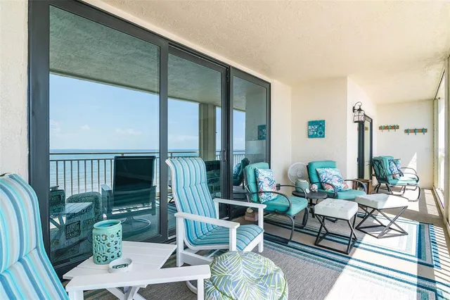 a balcony with furniture and wooden floor