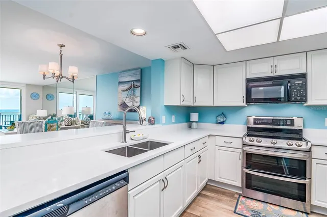 a kitchen with sink a stove and cabinets